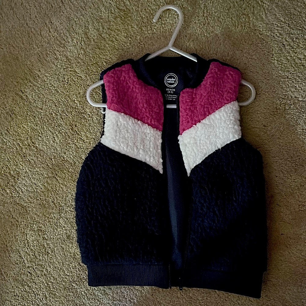 Vest has a main color of dark blue with pink/white (V) stripe in front.